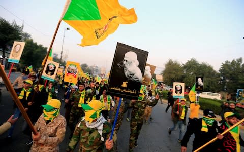 Kataib Hizbollah Iraqi militia gather ahead of the funeral of the Iraqi militia commander Abu Mahdi al-Muhandis - Credit: REUTERS/Thaier al-Sudani