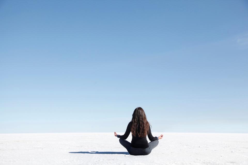 <h1 class="title">Woman meditation pose facing camera on salt flat</h1><cite class="credit">Photo: Michael Duva / Via Getty Images</cite>