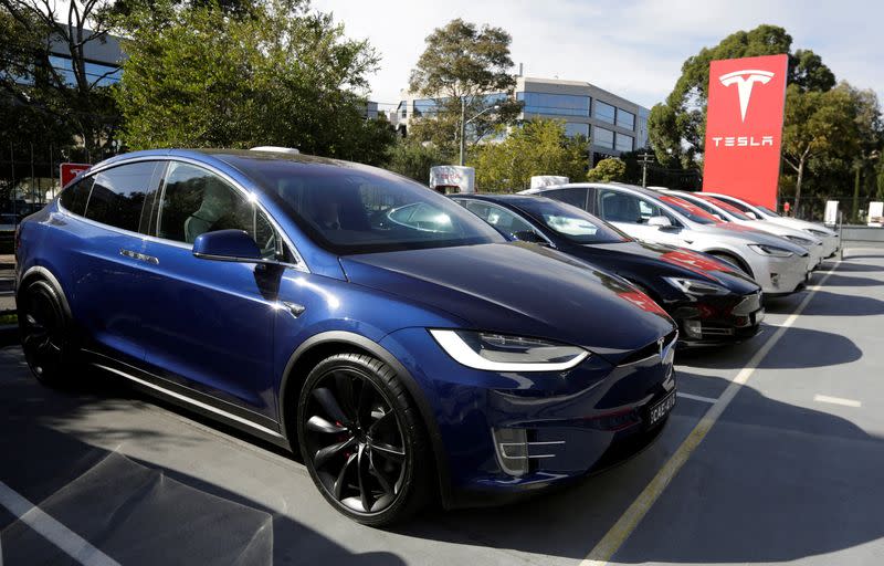 FILE PHOTO: A Tesla Model X car (front) and Model S (2nd L) are photographed at a Tesla electric car dealership in Sydney