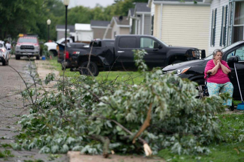 Mary Eideh, 72, looks on at tree damage outside of her Paree St. home in the Frenchtown Villas Monroe complex in Newport on Friday, Aug. 25, 2023 after a heavy band of storms hit the region on the evening of Thursday, Aug. 24, 2023.