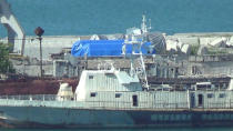 A still image taken from a video footage shows blue tarpaulins covering equipment at the port of Feodosia, Crimea July 11, 2017. Video footage taken July 11, 2017. REUTERS/Staff