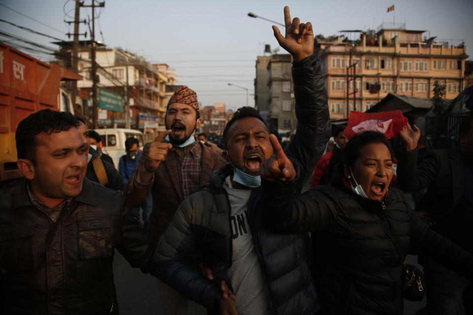 Nepalese students affiliated with Nepal Student Union shout slogans against prime minister Khadga Prasad Oli during a protest in Kathmandu, Nepal, Sunday, Dec. 20, 2020. Nepal’s president dissolved Parliament on Sunday after the prime minister recommended the move amid an escalating feud within his Communist Party that is likely to push the Himalayan nation into a political crisis. Parliamentary elections will be held on April 30 and May 10, according to a statement from President Bidya Devi Bhandari's office. (AP Photo/Niranjan Shrestha)