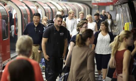 People disembark from a tube train at an underground station in London, Britain August 5, 2015. REUTERS/Paul Hackett