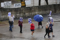 Picketers strike outside of the General Motors assembly plant, Tuesday, Oct. 24, 2023, in Arlington, Texas. The United Auto Workers union is turning up the heat on General Motors as 5,000 workers walked off their jobs at the highly profitable SUV factory. (AP Photo/Julio Cortez)