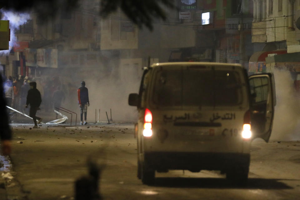 FILE - In this Jan.18, 2021 file photo, demonstrators face police officers during clashes in Ibn Khaldoun City near Tunis. A growing groundswell of youth unrest, tapping into a well of economic frustration, is sweeping Tunisia and worrying its leadership all the way to the top. It is, after all, the country that triggered 2011's Arab Spring revolutions. (AP Photo/Hassene Dridi, File)