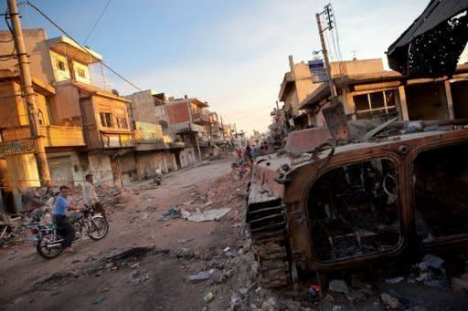 A destroyed Syrian forces tank remains in a damaged street in Atareb in northern Aleppo province on July 2. China joined Russia on Thursday in boycotting a meeting aimed at coordinating efforts to stop the bloodshed in Syria, where three senior army officers were among more than 150 people reported killed in 48 hours