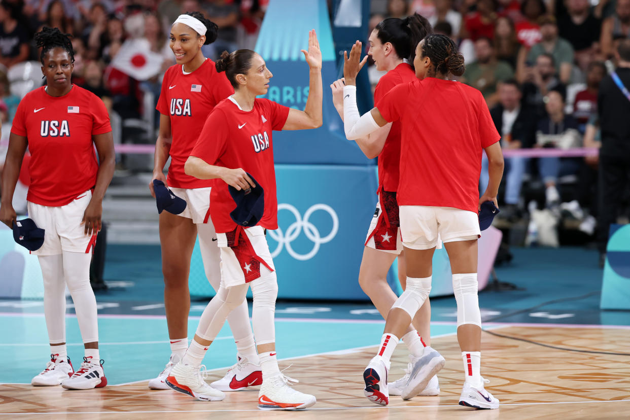 LILLE, FRANCE - JULY 29: Diana Taurasi #12 of Team United States high fives teammates before the Women's Group Phase - Group B game between Japan and United States on day three of the Olympic Games Paris 2024 at Stade Pierre Mauroy on July 29, 2024 in Lille, France. (Photo by Gregory Shamus/Getty Images)