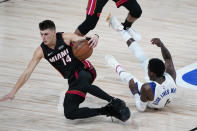 Miami Heat guard Tyler Herro (14) and Indiana Pacers guard Victor Oladipo, right, scramble for a loose ball during the second half of an NBA basketball first round playoff game, Saturday, Aug. 22, 2020, in Lake Buena Vista, Fla. (AP Photo/Ashley Landis, Pool)