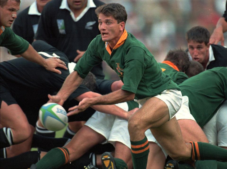 FILE - In this Saturday, June 24, 1995 file photo, South Africa's scrumhalf Joost van der Westhuizen lets fly a pass during the World Cup final against New Zealand at Ellis Park in Johannesburg. Joost van der Westhuizen, who won the 1995 World Cup with South Africa as Nelson Mandela looked on, has died after a six-year-battle with motor neuron disease. He was 45. South Africa Rugby announced the death Monday, Feb. 6, 2017. (AP Photo/John Parkin, file)