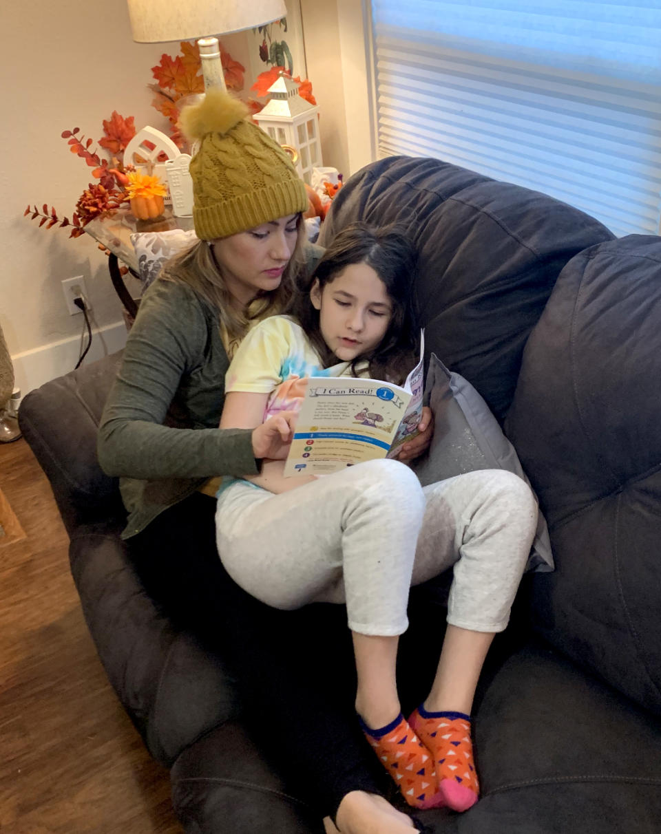 Image: Angelica Gonzalez and her daughter, Lolly, read on the couch at home. (Courtesy of Angelica Gonzalez)