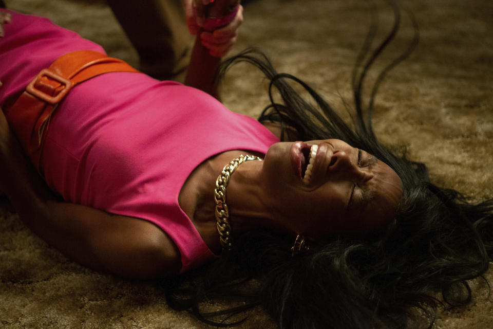 This image released by Hulu shows Elle Lorranie in a scene from "Bad Hair," a comedy-horror about a woman trying to rise in the late-80s music business who gets a demonic weave. The film premieres Friday on Hulu. (Tobin Yellan/Hulu via AP)