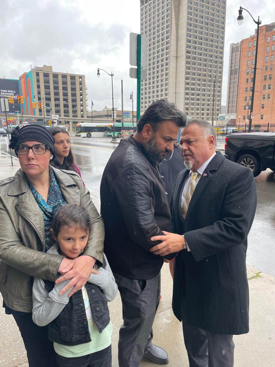 Yahya Alarayshi speaks with Nabih Ayad, of the Arab American Civil Rights League, at a news conference about their parents trapped in Gaza and seeking the help of the U.S. government to evacuate them. His wife, Lisa, stands next to him along with other family members.