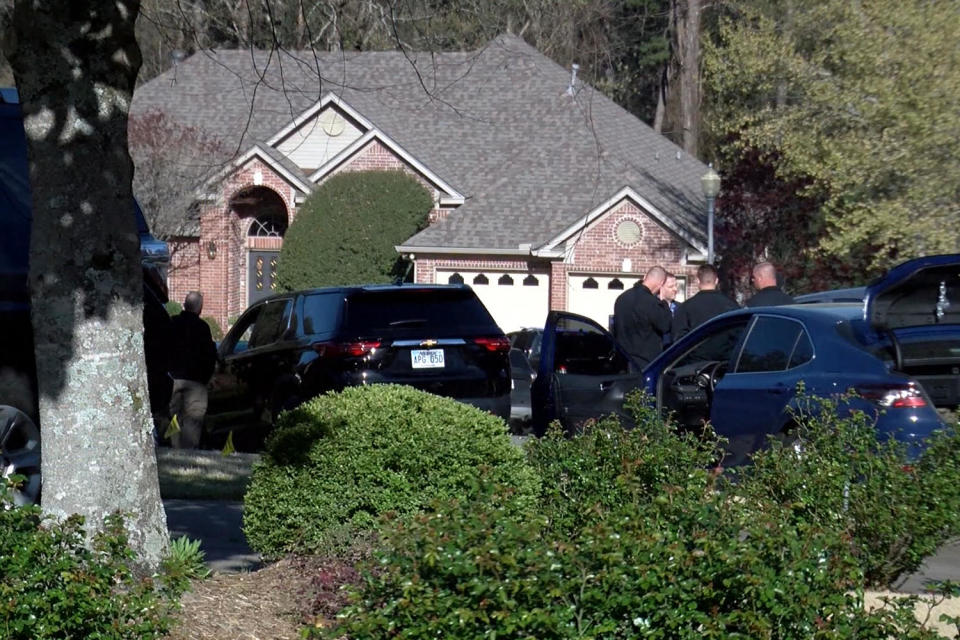 A screenshot of law enforcement officials and vehicles outside a home in west Little Rock, Ark., (KARK)