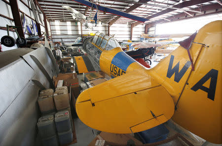 A a vintage T-6 'Texan' plane at Warbird Adventures is stored with supplies and other aircraft inside a packed hangar at Kissimmee Gateway Airport, in preparation for the arrival of Hurricane Irma making landfall, in Florida, U.S. September 7, 2017. REUTERS/Gregg Newton