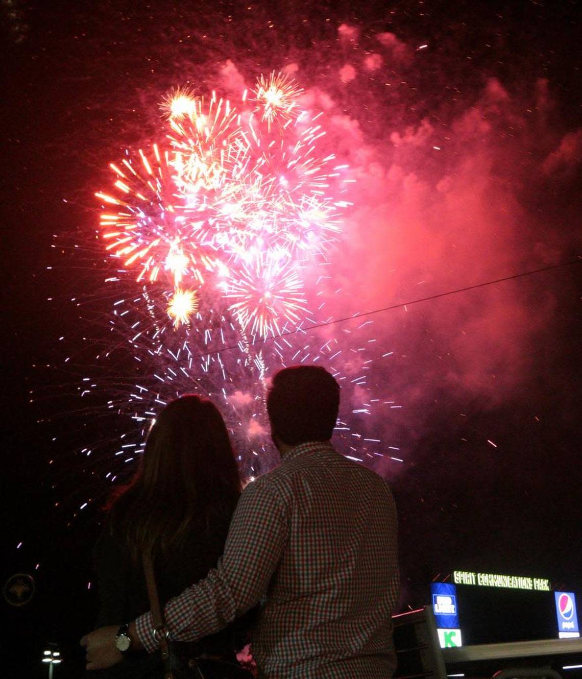 Fans watch a fireworks show at Segra Park