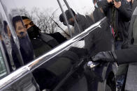 Actor Jussie Smollett is reflected in a vehicle window as he reaches for the door handle after departing Tuesday, Dec. 7, 2021, the Leighton Criminal Courthouse after day six of his trial in Chicago. Closing arguments will begin Wednesday, in Chicago. (AP Photo/Charles Rex Arbogast)