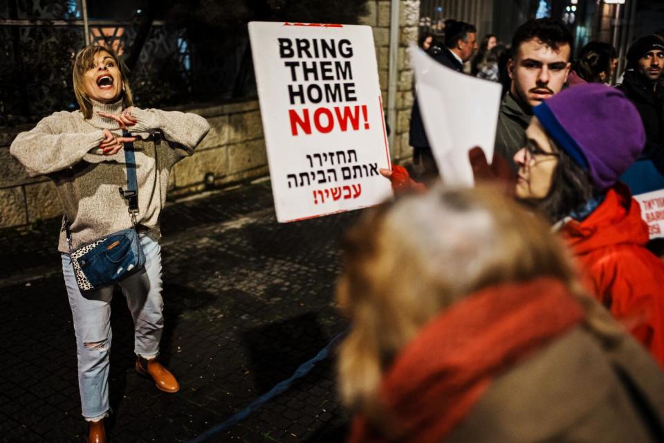 A bystander who is voicing support for Prime Minister Netanyahu argues with passing protesters.