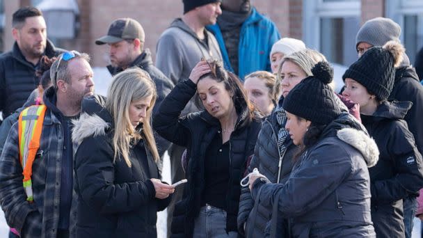 PHOTO: Parents wait for news after a bus crashed into a daycare centre in Laval, Quebec, Feb. 8, 2023. (Ryan Remiorz/The Canadian Press via AP)