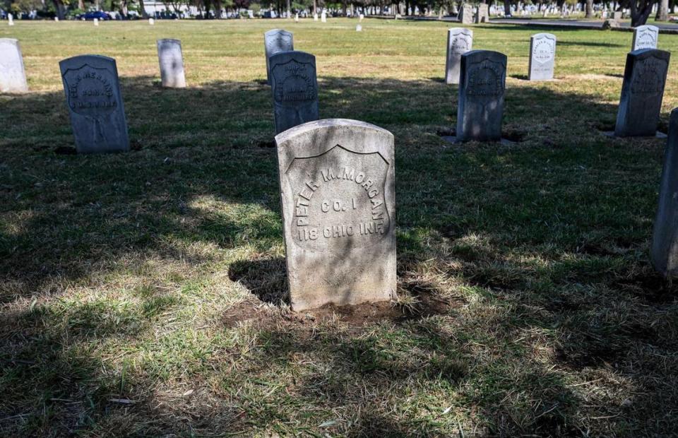 A veterans headstone is illuminated in the afternoon light at the Veterans Liberty Cemetery in Fresno on Friday, April 28, 2023.