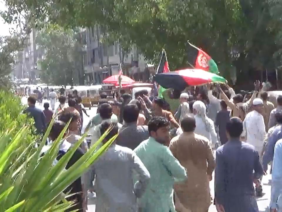 People carry Afghan flags as they take part in an anti-Taliban protest in Jalalabad, Afghanistan August 18, 2021 in this screen grab taken from a video.