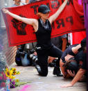 <p>A group wearing anti-fascist labels visits the site where Heather Heyer was killed during the 2017 Charlottesville “Unite the Right” protests in Charlottesville, Va., Aug. 11, 2018. (Photo: Brian Snyder/Reuters) </p>