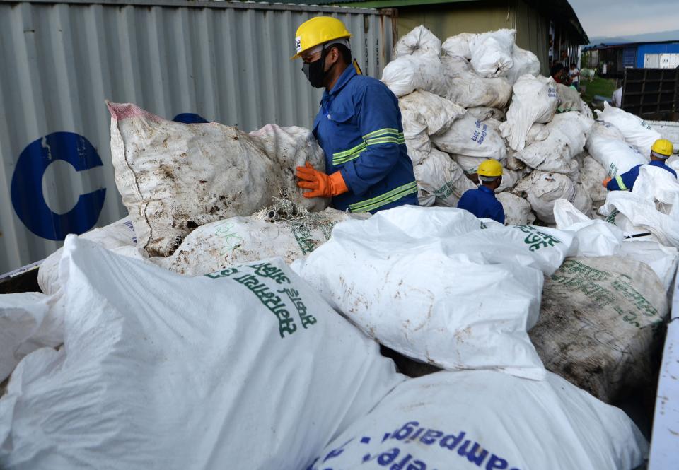 Nepali workers pile up sacks of waste collected from Mount Everest for recycling, in Kathmandu on June 5, 2019. - Nepal's government sent a dedicated clean-up team to Mount Everest this season with a target to bring back 10 tonnes of trash in an ambitious plan to clean the world's highest rubbish dump. (Photo by PRAKASH MATHEMA / AFP)        (Photo credit should read PRAKASH MATHEMA/AFP/Getty Images)