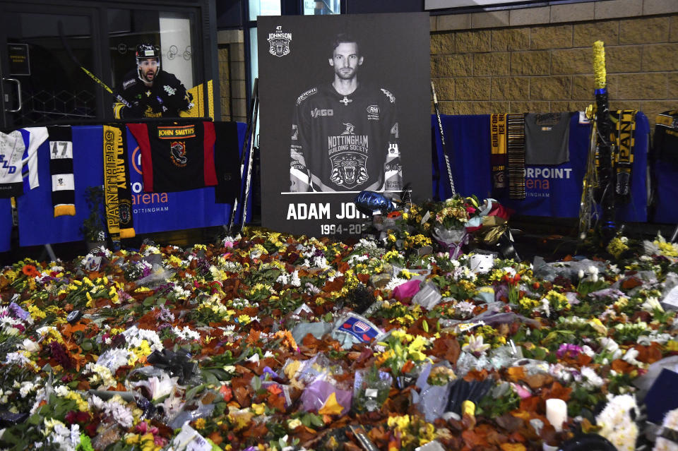 Flower tributes for Nottingham Panthers player Adam Johnson rest outside the Motorpoint Arena before a memorial ice hockey game between Nottingham Panthers and Manchester Storm in Nottingham, England, Saturday, Nov. 18, 2023. The memorial game is held three weeks after Adam Johnson, 29, suffered a fatal cut to his neck during a game against Sheffield Steelers on Saturday, Oct. 28, 2023. (AP Photo/Rui Vieira)