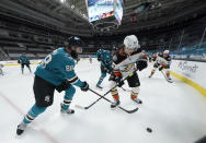 San Jose Sharks defenseman Brent Burns (88) works for the puck along the boards against Anaheim Ducks center Rickard Rakell (67) during the second period of an NHL hockey game Wednesday, April 14, 2021, in San Jose, Calif. (AP Photo/Tony Avelar)