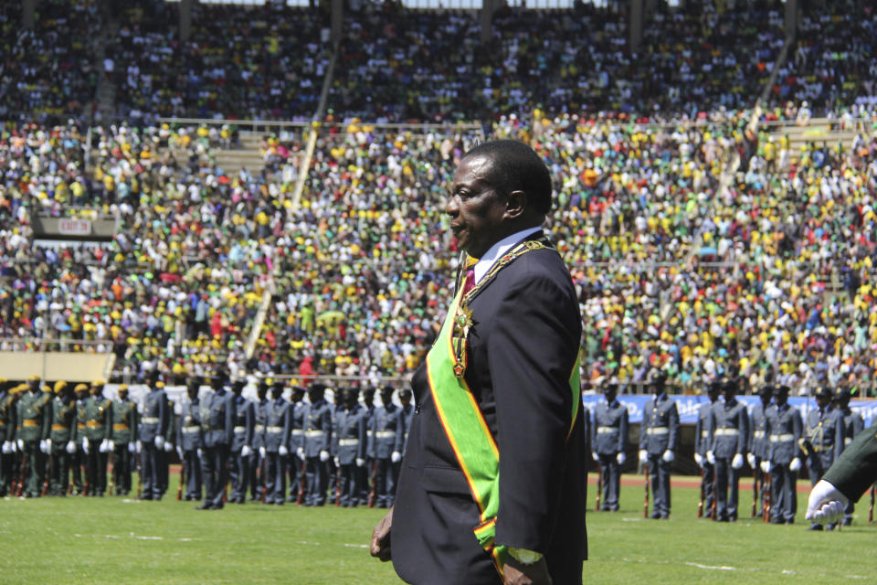 Zimbabwean President Emmerson Mnangagwa inspects the guard of honour during his inauguration ceremony at the National Sports Stadium in Harare, Sunday, Aug. 26, 2018. The Constitutional Court upheld Mnangagwa's narrow election win Friday, saying the opposition did not provide " sufficient and credible evidence" to back vote-rigging claims.(AP Photo/Tsvangirayi Mukwazhi)