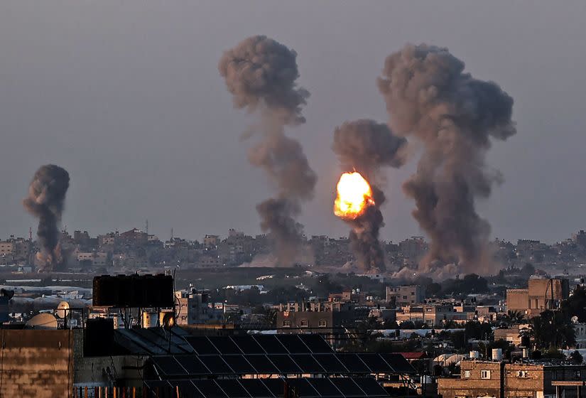 Smoke and a ball of fire rise above buildings in Khan Yunis in the southern Gaza Strip, during an Israeli air strike, on May 12, 2021. - Israeli air raids in the Gaza Strip have hit the homes of high-ranking members of the Hamas militant group, the military said Wednesday, with the territory's police headquarters also targeted. (Photo by SAID KHATIB / AFP) (Photo by SAID KHATIB/AFP via Getty Images)