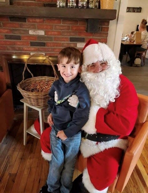 Cash Kenney of Perry Township meets Santa Claus during Navarre's Christmas in Bethlehem in 2023. Organizers are planning to host the holiday event on Nov. 16 in 2024.