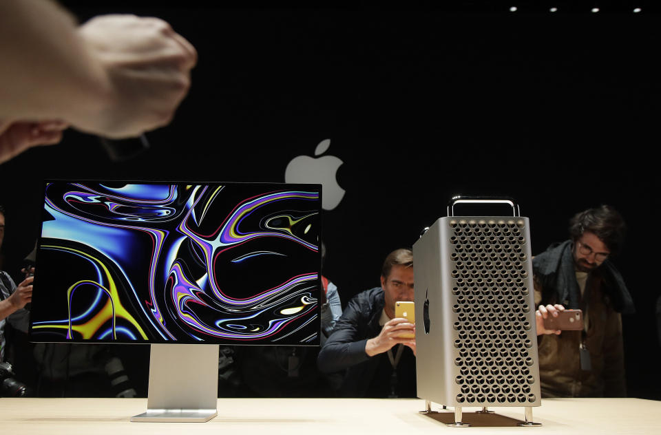 People take pictures of the Mac Pro in the display room at the Apple Worldwide Developers Conference in San Jose. 
