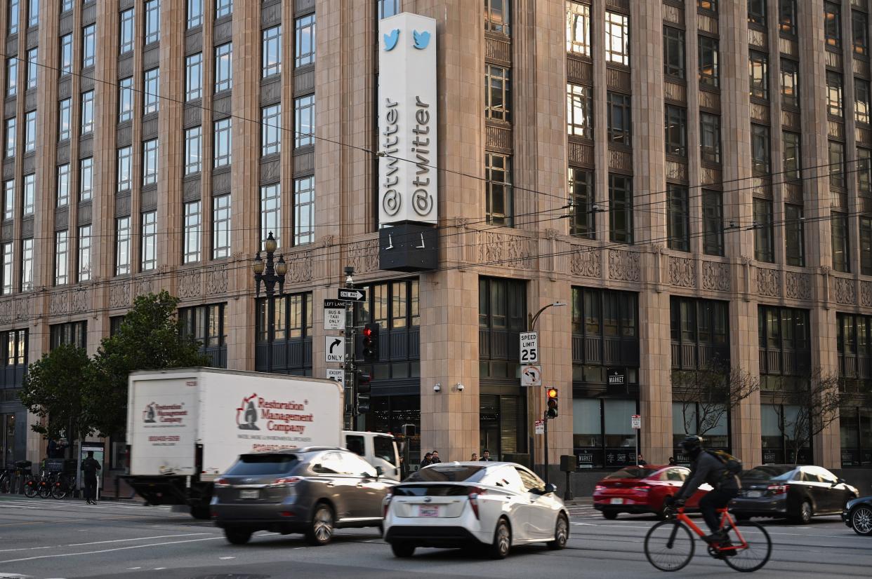 Traffic passes the corner of the Twitter building.
