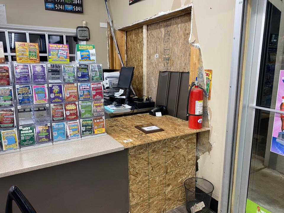 Plywood covers the hole Jan. 23, 2020, near the front entrance inside of the PS Food Mart in Clayton where a pickup crashed Jan. 21, 2020, seriously injuring employee Eva Gonzalez. Gonzalez's employee of the month plaque is on the desk. The pickup's driver, Gary Franklin Krohn, pleaded no contest May 11, 2022, to operating while intoxicated causing serious injury.
