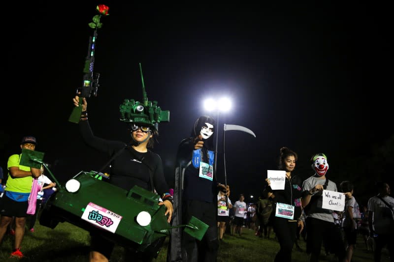 Runners dressed in costumes attend a "Run Against Dictatorship" event at a public park in Bangkok