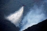 FILE PHOTO: A helicopter makes a water drop over a wildfire in the Angeles National Forest during the Bobcat Fire in Los Angeles