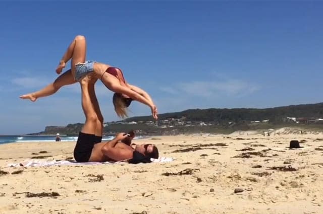 Aussie man makes surprise proposal to his girlfriend during beach 'acro-yoga'