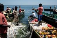 Fishermen preparing their nets on Migingo island whose surrounding waters abound with Nile Perch
