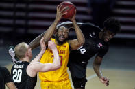 Maryland forward Galin Smith, center, is fouled while going up for a shot against Michigan State forward Gabe Brown, right, and forward Joey Hauser during the second half of an NCAA college basketball game, Sunday, Feb. 28, 2021, in College Park, Md. Maryland won 73-55. (AP Photo/Julio Cortez)