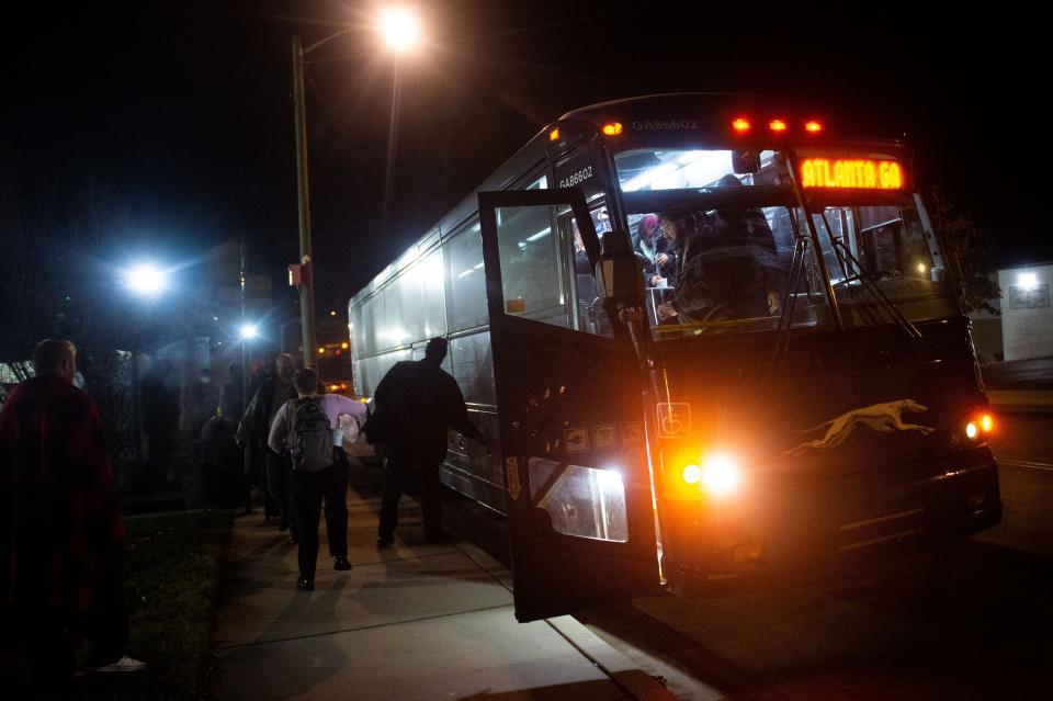 Riders retrieve their items from the Greyhound bus at the KAT East Superstop on 100 Kirkwood St. on Tuesday, Nov. 22, 2022. 