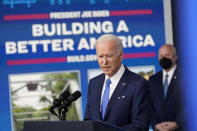 President Joe Biden speaks about the Bipartisan Infrastructure Law at the South Court Auditorium in the Eisenhower Executive Office Building on the White House Campus in Washington, Friday, Jan. 14, 2022, as Mitch Landrieu, Senior Advisor & Infrastructure Act Implementation Coordinator, looks on. (AP Photo/Andrew Harnik)