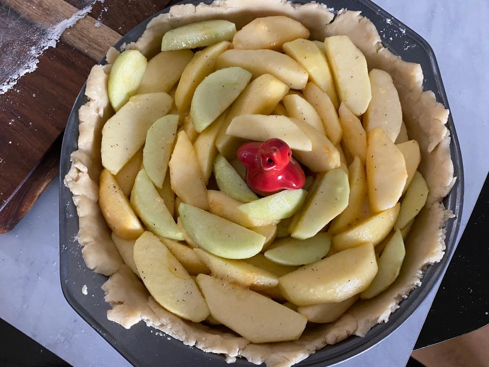 A pie with stacked apple wedges.