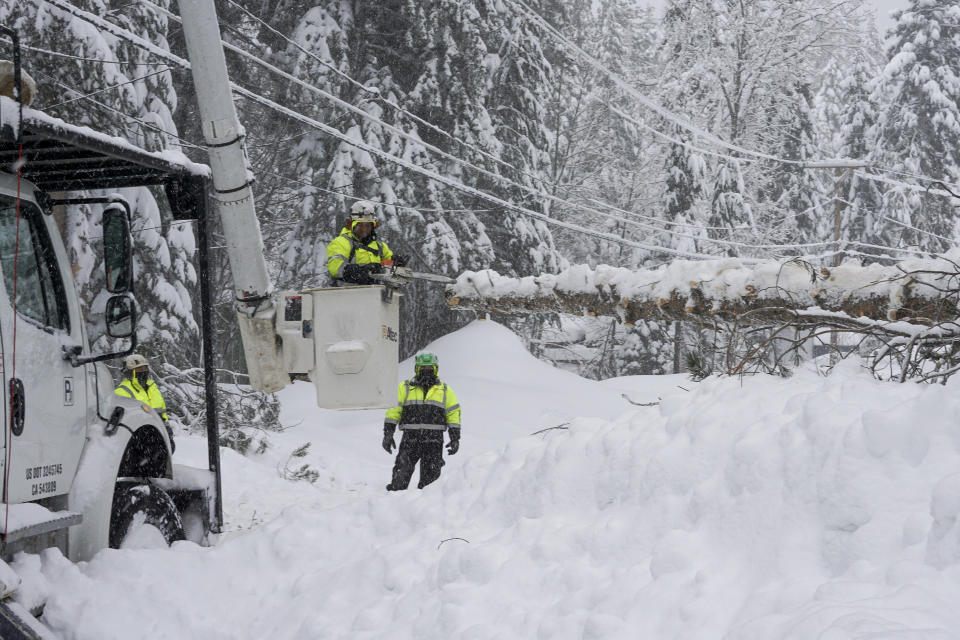 Crews clears trees along Donner Lake, where power was lost due to a snow storm, Saturday, March 2, 2024, in Truckee, Calif. (AP Photo/Brooke Hess-Homeier)