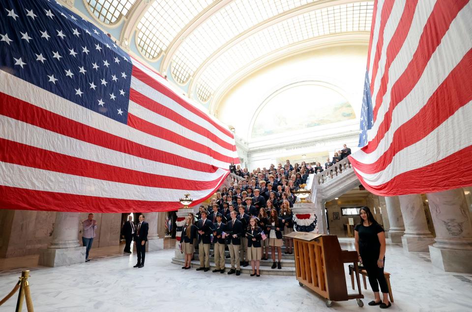 The American Heritage School Choir stands between two giant American flags during the Constitution Month kickoff event at the Capitol in Salt Lake City on Thursday, Aug. 31, 2023. | Kristin Murphy, Deseret News