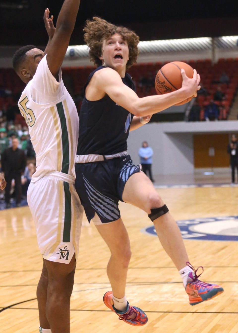 Will Aljancic, 1, of Louisville goes to the basket while being guarded by Darius Stratford, 35, of Akron St. Vincent-St. Mary during their DII regional final at the Canton Memorial Civic Center on Saturday, March 12, 2022.