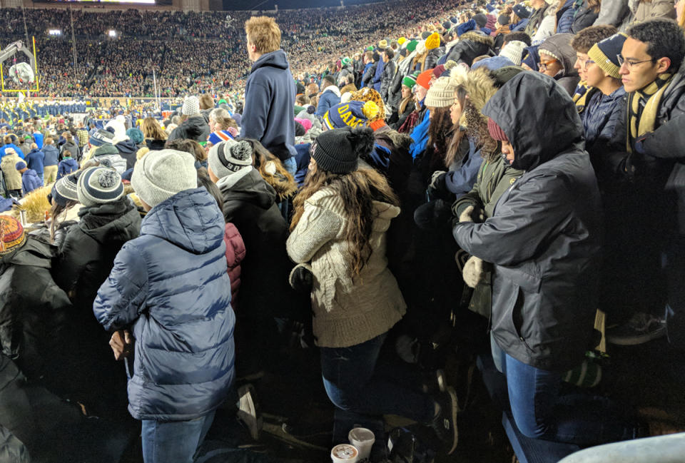 A group of Notre Dame students kneel during the playing of the national anthem prior to Saturday’s game in South Bend. (Courtesy of <a href="https://ndsmcobserver.com/2018/11/students-kneel-during-national-anthem/" rel="nofollow noopener" target="_blank" data-ylk="slk:Andrew Cameron/The Observer;elm:context_link;itc:0;sec:content-canvas" class="link ">Andrew Cameron/The Observer</a>)