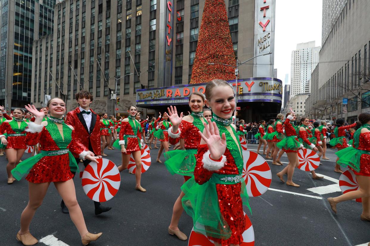 New York, New York - November 28, 2019: Performers dressed as Santas helpers wave to the crowd in the 93rd Macy's Thanksgiving Day Parade in New York, New York on November 28, 2019. (Photography by Gordon Donovan)