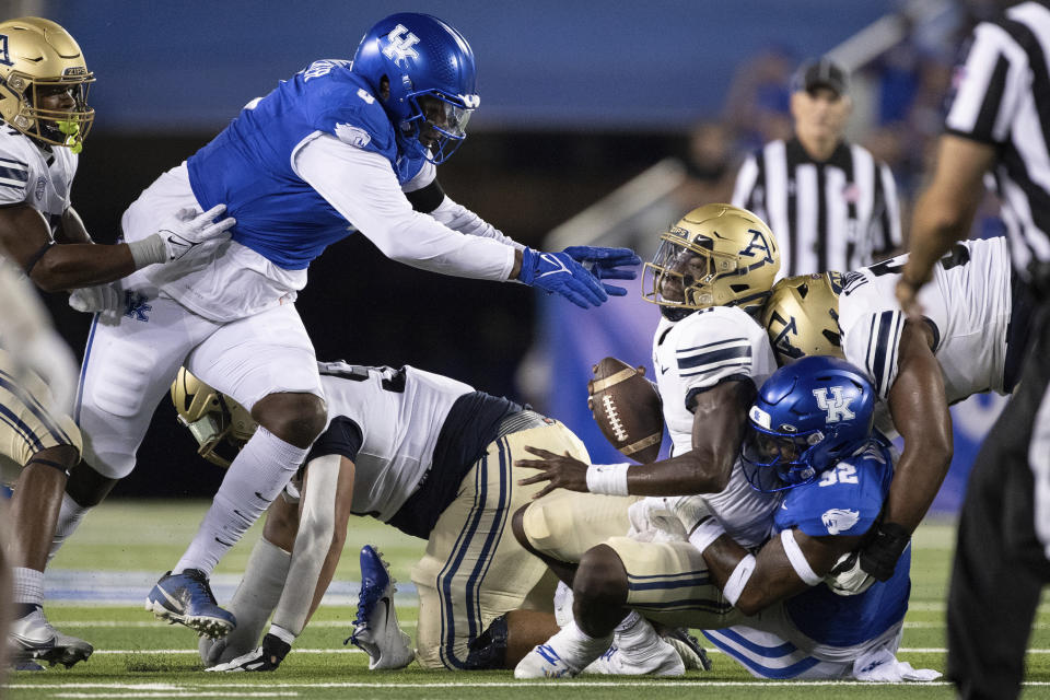 Kentucky defensive lineman Deone Walker (0) and Kentucky linebacker Trevin Wallace (32) sack Akron quarterback DJ Irons (0) during the first half of an NCAA college football game in Lexington, Ky., Saturday, Sept. 16, 2023. (AP Photo/Michelle Haas Hutchins)