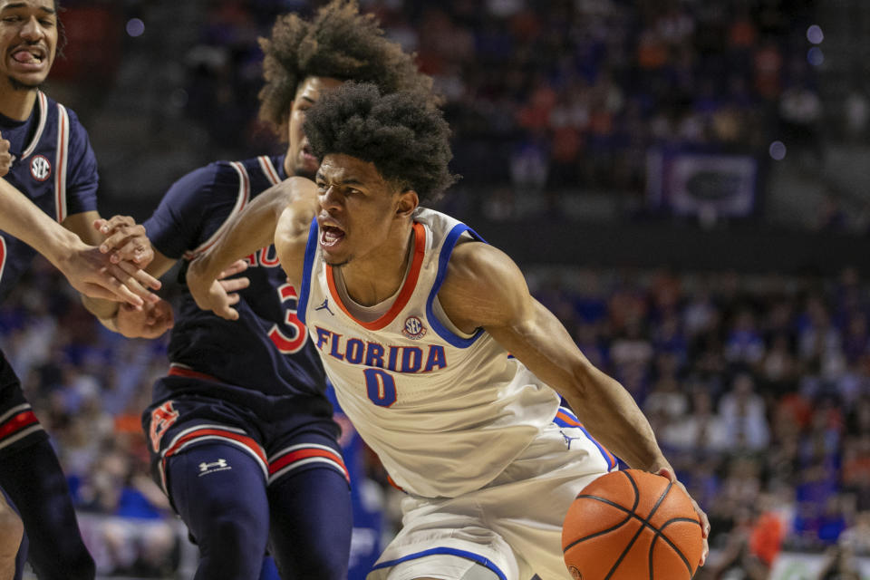 Florida guard Zyon Pullin (0) drives against Auburn guard Tre Donaldson (3) during the first half of an NCAA college basketball game, Saturday, Feb. 10, 2024, in Gainesville, Fla. (AP Photo/Alan Youngblood)