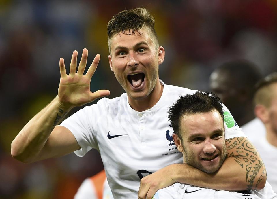 France's Olivier Giroud (top) celebrates with teammate Mathieu Valbuena their team's victory over Switzerland after their 2014 World Cup Group E soccer match at the Fonte Nova arena in Salvador June 20, 2014. REUTERS/Dylan Martinez